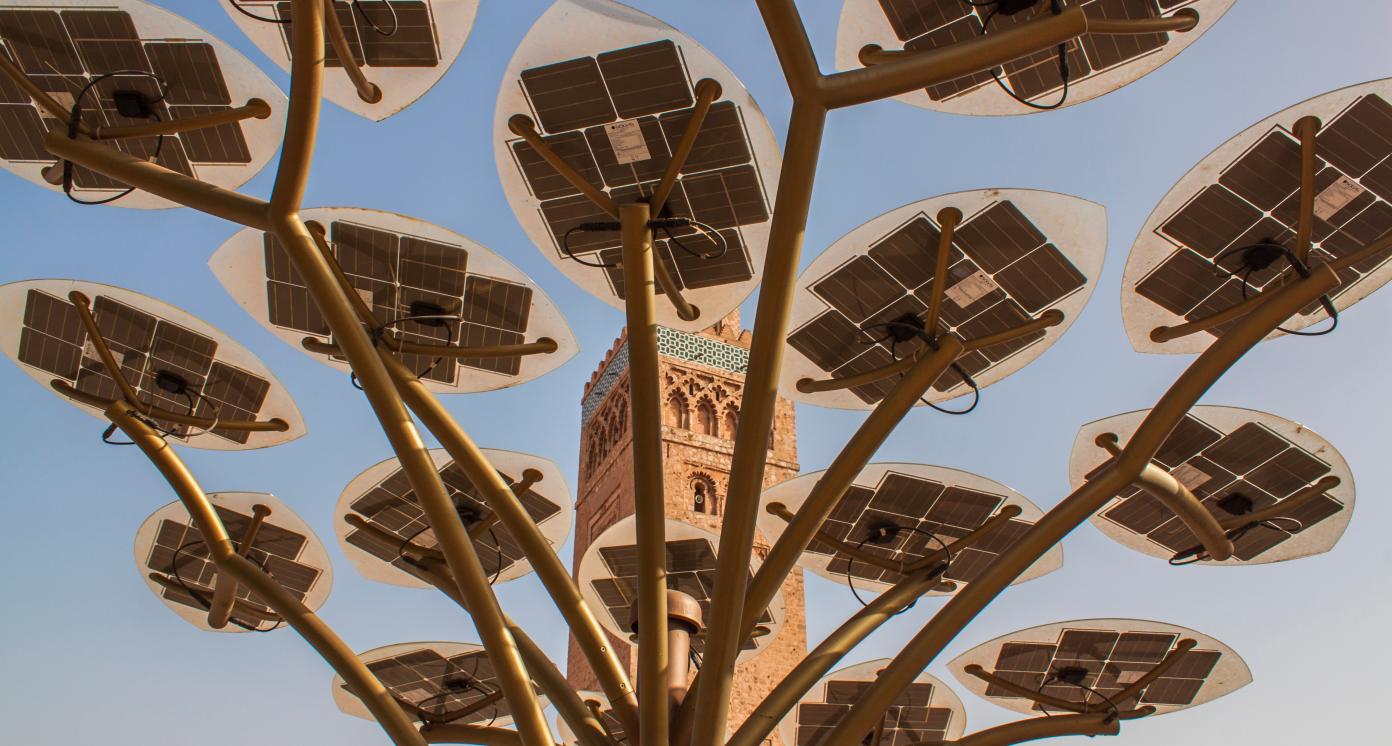 Solar cells and the tower of the Koutoubia Mosque in the old town of Marrakesh, Morocco, Africa. Eco energy, alternative energy, sustainable industry, ecosystem and healthy environment concepts.