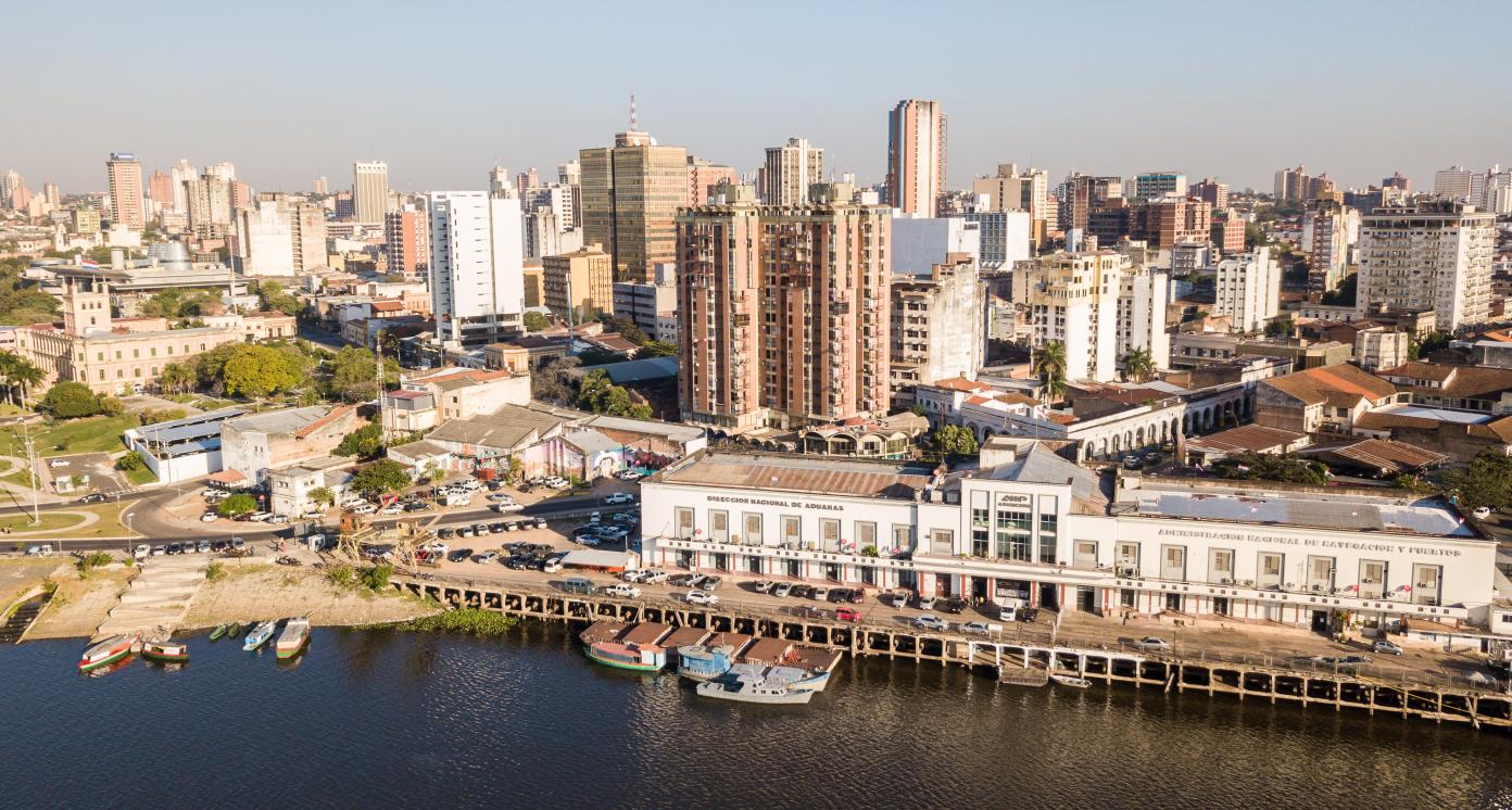 ASUNCION, PARAGUAY - July 13, 2018: Panoramic view of skyscrapers skyline of Latin American capital of Ciudad de Asunción Paraguay and Embankment of Paraguay river as seen in aerial drone photo.