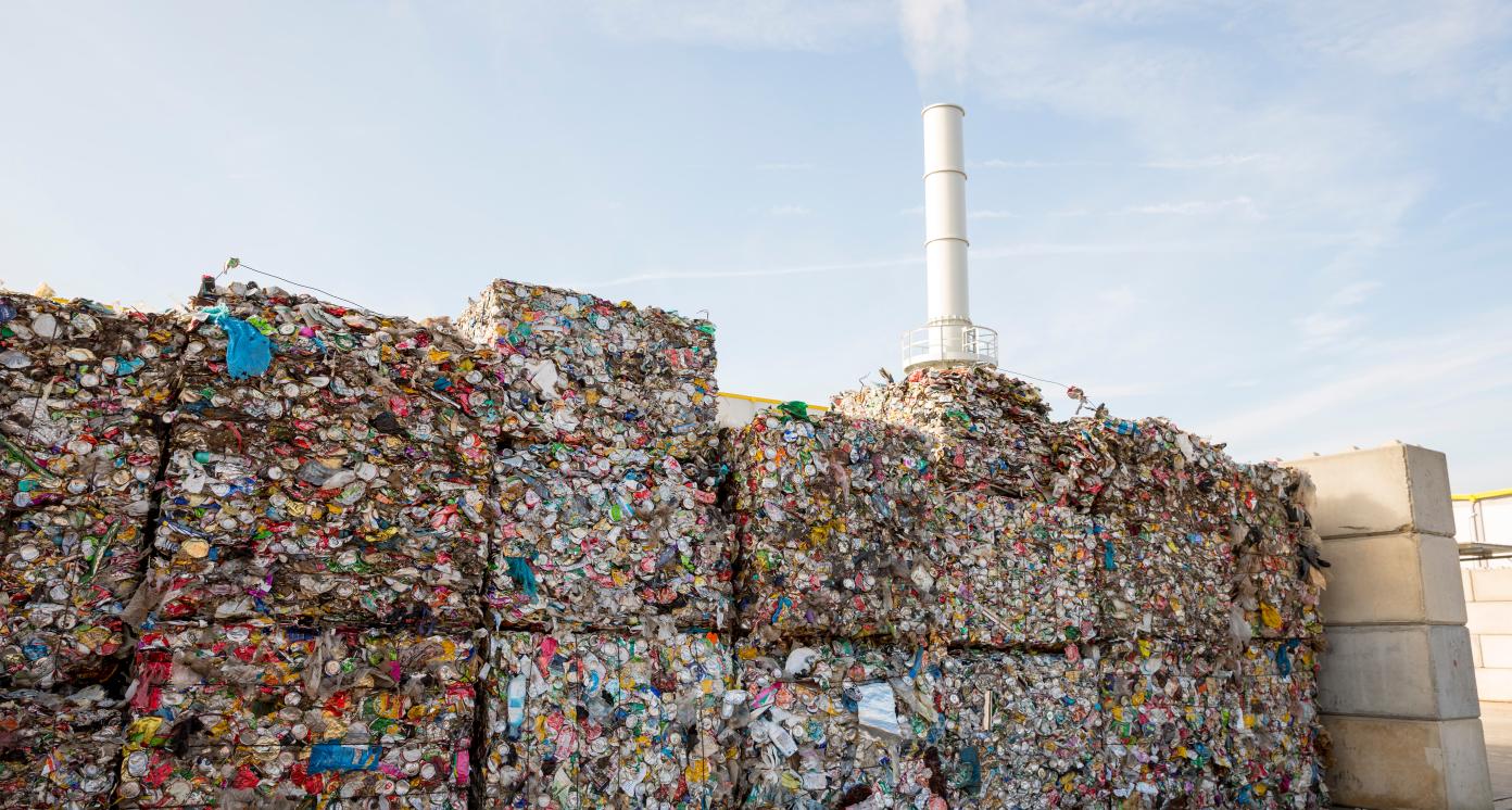 Waste-to-energy or energy-from-waste is the process of generating energy in the form of electricity or heat from the primary treatment of waste. Cubes of pressed metal beer and soda cans.