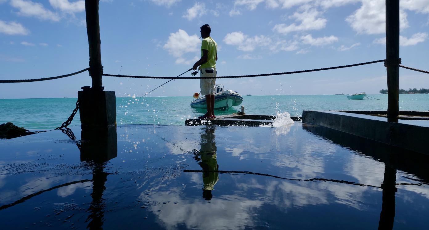 Local fisherman with fishing. Mauritius, Coral Azur Resort.