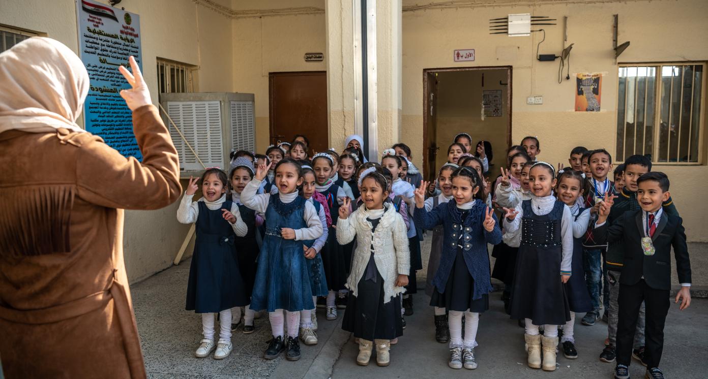 21 February 2019, Mosul, Iraq. Students at the Izzdin al Qassan Mixed Primary School in East Mosul sing and recite poetry during a weekly flag raising routine. During the battle to liberate Mosul from ISIS control the school was damaged after being hit by several mortars and rockets. It has since been rehabilitated with the support of UNDP’s Funding Facility for Stabilization (FFS). 