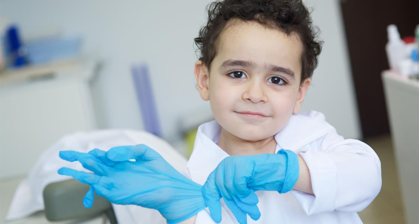 Playing dentist in the dental office. Little doctor baby boy.