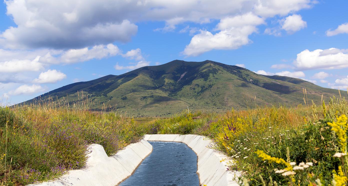 View of Mount Arailer. Irrigation canal in the valley between the mountains. Armenia