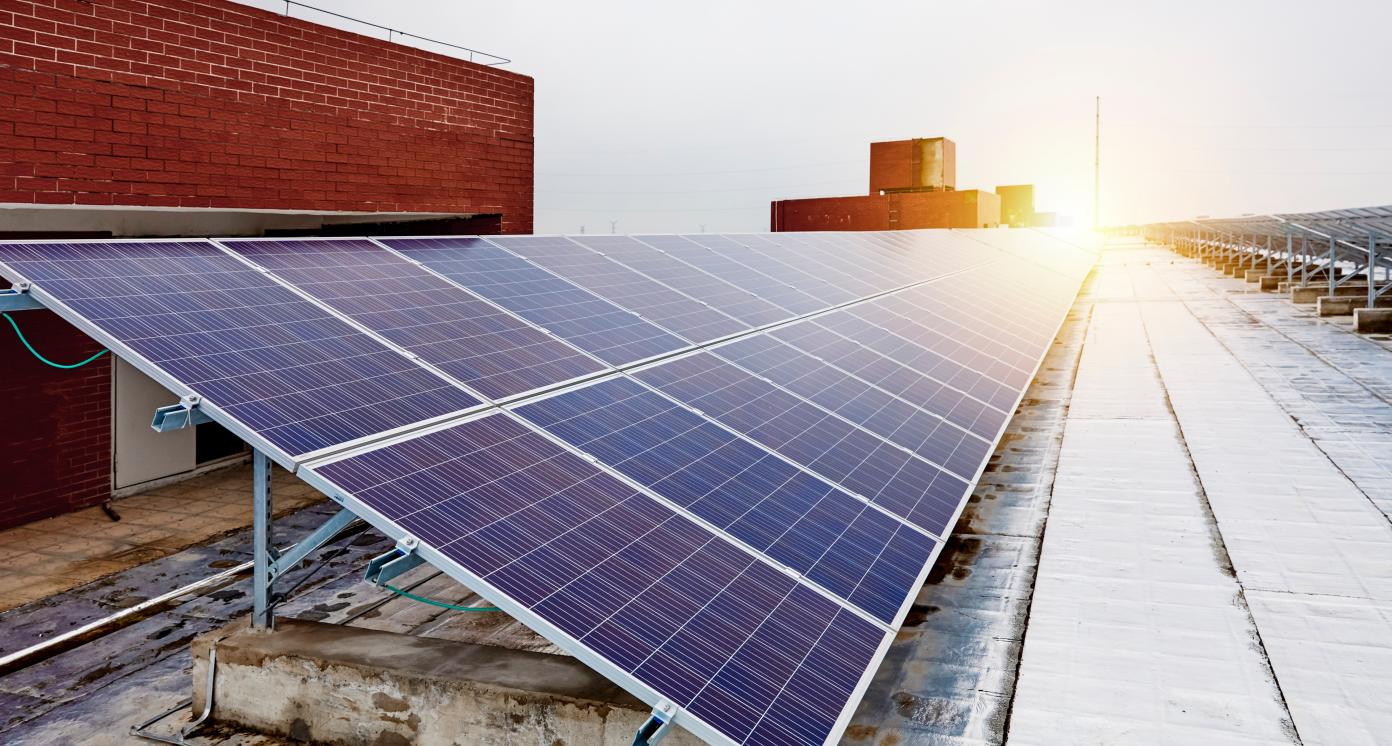 Solar photovoltaic panels built on the roof of an insulated factory building