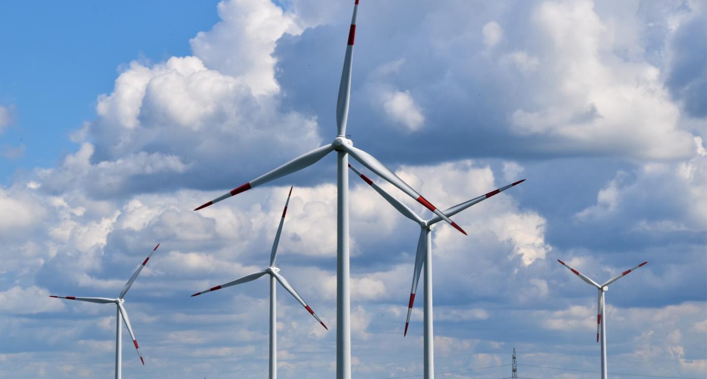 wind turbines on green grass fields