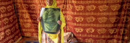 TB campaign in Djibouti, woman holding up x ray image