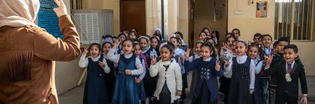 21 February 2019, Mosul, Iraq. Students at the Izzdin al Qassan Mixed Primary School in East Mosul sing and recite poetry during a weekly flag raising routine. During the battle to liberate Mosul from ISIS control the school was damaged after being hit by several mortars and rockets. It has since been rehabilitated with the support of UNDP’s Funding Facility for Stabilization (FFS). 