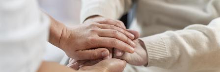 Doctor holding hands of a senior patient