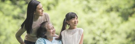 Happy grandmother in wheelchair with daughter and grand daughter