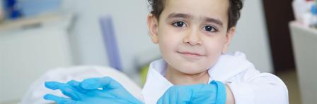 Playing dentist in the dental office. Little doctor baby boy.