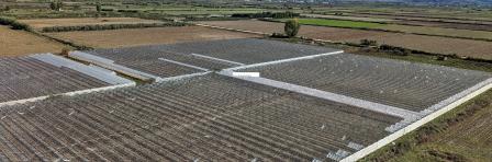 "greenhouses under the mountains in Sarande region of Albania,Balkan, aerial panorama landscape view "