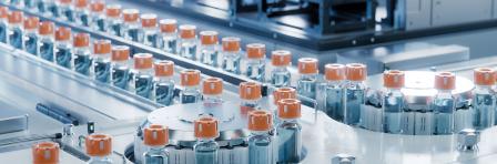 Vaccine Production Facility. Medication Manufacturing Process. Glass Vials with Orange Caps on Conveyor Belt. Medical Ampoule Production Line at Modern Pharmaceutical Factory.